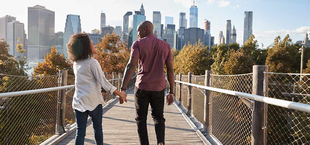 What types of cannabis are legal in NY? Couple walking on bridge in NY