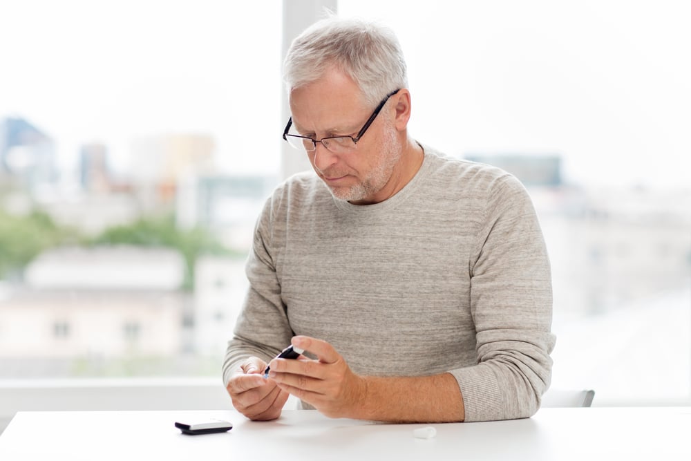 man taking a diabetes test