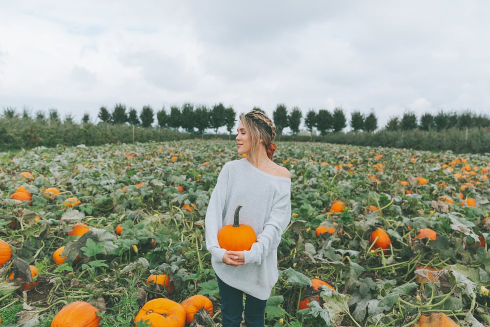 woman holding pumpkin for halloween