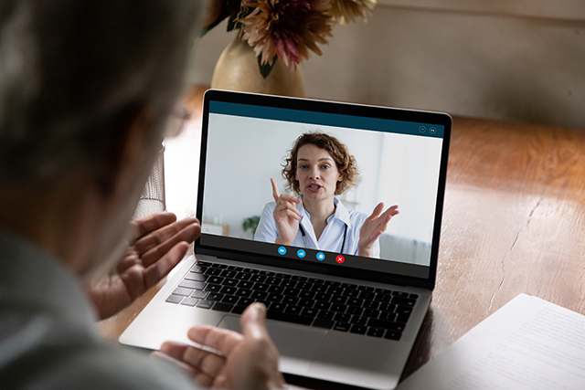 Man on video call with female doctor, having online consultation at home