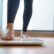 woman checking scale for zepbound weight loss results