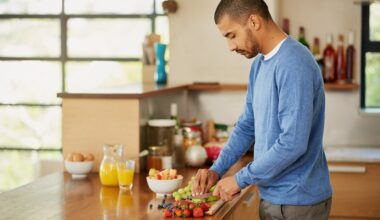 A man cutting up fruit to eat, enjoying a nutritous meal