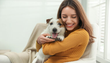 Woman cuddling her Emotion Support Animal in her home