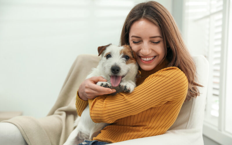 Woman cuddling her Emotion Support Animal in her home