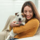 Woman cuddling her Emotion Support Animal in her home