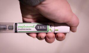 Someone holding a Zepbound injection pen