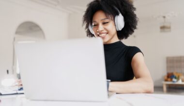 Woman sitting at her computer happily