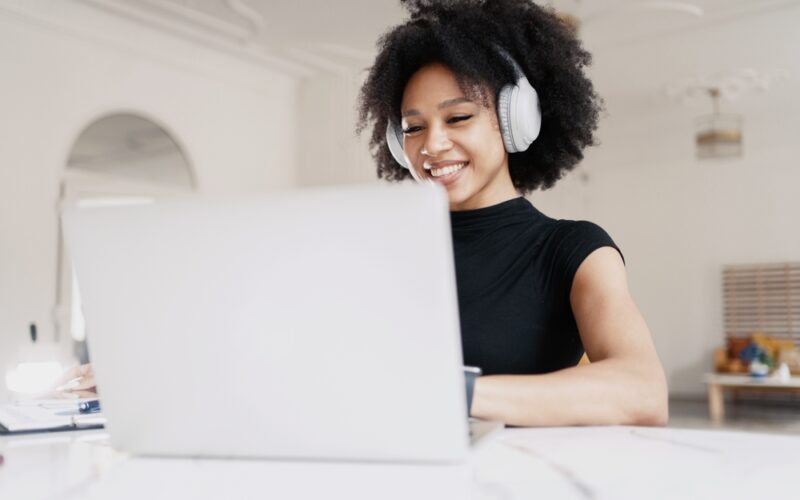 Woman sitting at her computer happily