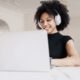 Woman sitting at her computer happily