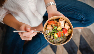 Woman eating a healthy meal with good protein and veggies