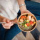 Woman eating a healthy meal with good protein and veggies