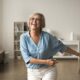 Happy older woman energized and dancing in her home