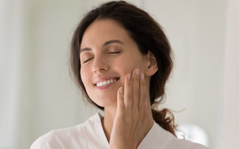 Young woman appreciating her skin