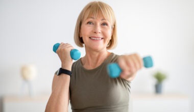 Older woman smiling and doing a home exercise