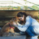 Woman hugging her dog and having an emotional moment
