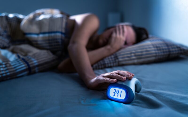 Woman can't sleep late at night, dealing with insomnia