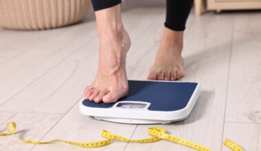 Woman stepping on scale to check weight