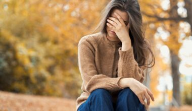 Woman sitting in park unhappy, dealing with depression