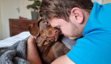 Man giving his dog a hug