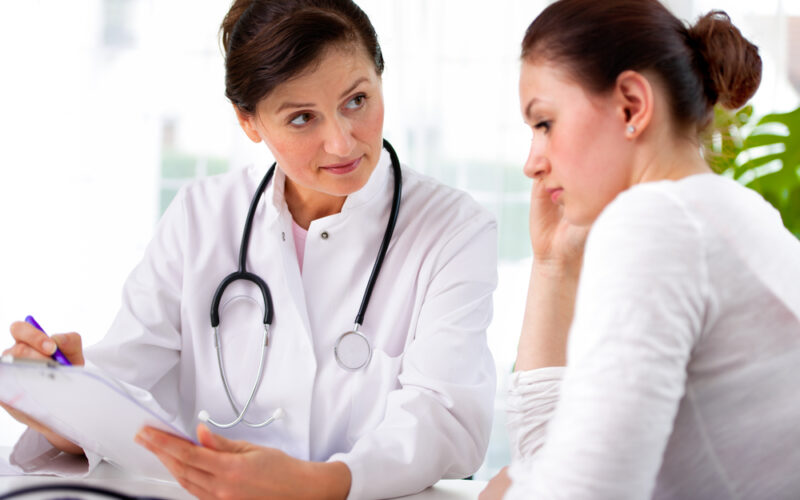 Doctor having a consultation with a young woman