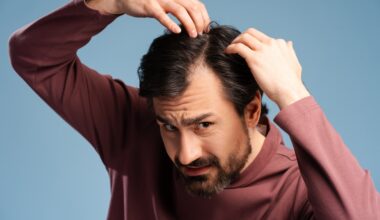Man dealing with hair loss and showing his concern