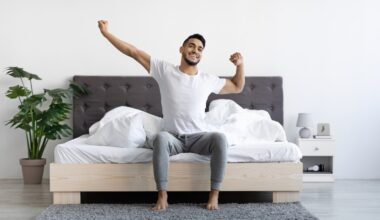 Happy young man waking up after having a good night of sleep