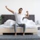 Happy young man waking up after having a good night of sleep