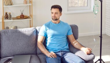 Man sitting on couch receiving IV therapy