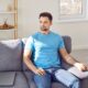 Man sitting on couch receiving IV therapy
