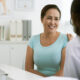 Middle aged woman smiling during consultation with doctor