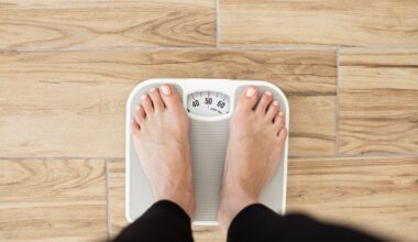 Close up of someone standing on a scale and weighing themselves