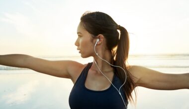 Woman with earphones in doing yoga and experiencing mental clarity