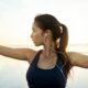 Woman with earphones in doing yoga and experiencing mental clarity