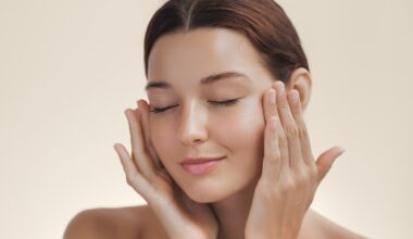 Up close image of model showing off her skin while touching her face