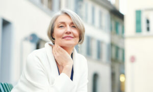 Close up outdoor photo of older woman with radiant skin
