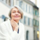 Close up outdoor photo of older woman with radiant skin