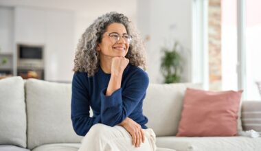 Happy and relaxed middle aged woman sitting on her couch