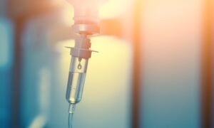 Vitamin IV drip infusion therapy in a medical setting. Close-up of intravenous therapy with liquid nutrients for health and wellness.”
