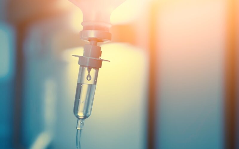 Vitamin IV drip infusion therapy in a medical setting. Close-up of intravenous therapy with liquid nutrients for health and wellness.”