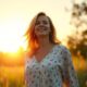 A serene 40 year old fresh energized woman standing in nature during golden hour