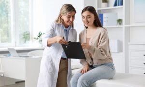 Professional doctor working with patient in hospital talking about DHEA