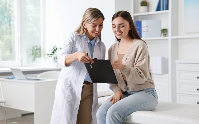 Professional doctor working with patient in hospital talking about DHEA