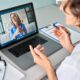 Female doctor therapist consulting older senior patient via virtual video call visit using laptop computer. Digital online healthcare, distance telemedicine. Telehealth videocall. Over shoulder view
