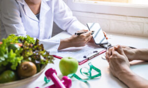 Doctor guiding patient and creating roadmap to lose weight through diet, exercise, and medication