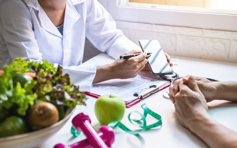 Doctor guiding patient and creating roadmap to lose weight through diet, exercise, and medication