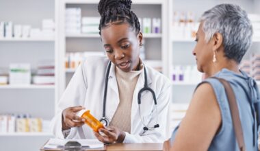 Pharmacist explaining medication to a patient while holding a prescription bottle, providing guidance on dosage and discussing liraglutide cost.