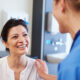 Female Patient Being Reassured By Doctor In Hospital Room