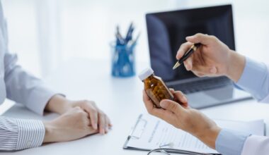 Doctor holding a pill bottle while consulting with a patient, discussing treatment options and differences between liraglutide and semaglutide.