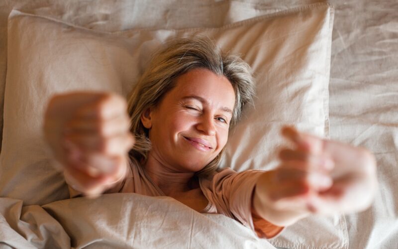 woman waking up fresh in bed