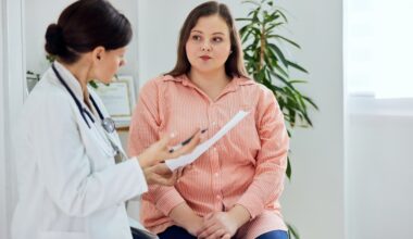 Doctor reviewing medical notes with a patient during consultation, evaluating whether she is a suitable liraglutide candidate for treatment.